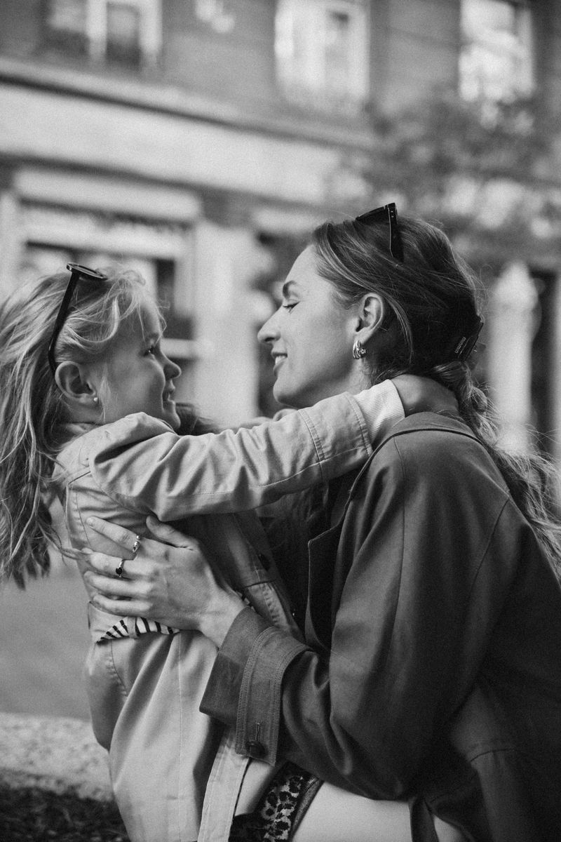 Black and white: a mother lifts her daughter into a hug